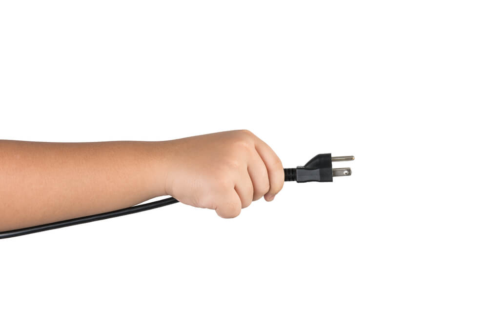 Child holding electrical cord
