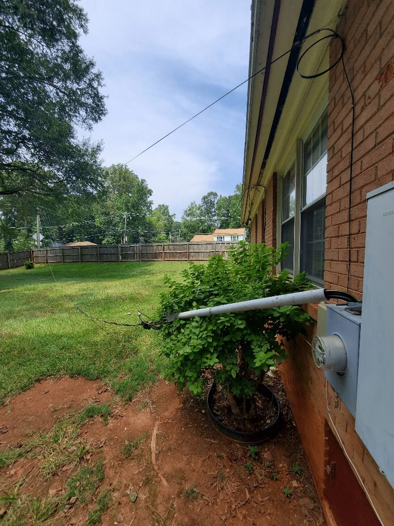 After a storm a tree limb fell taking the service mast off the house and the powerline down to the ground causing electrical problems.