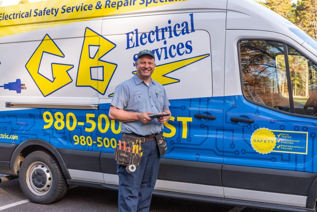 GB Electrical Electrician next to van