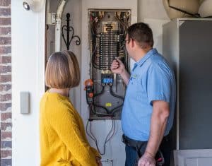 Electrician working on electrical panel